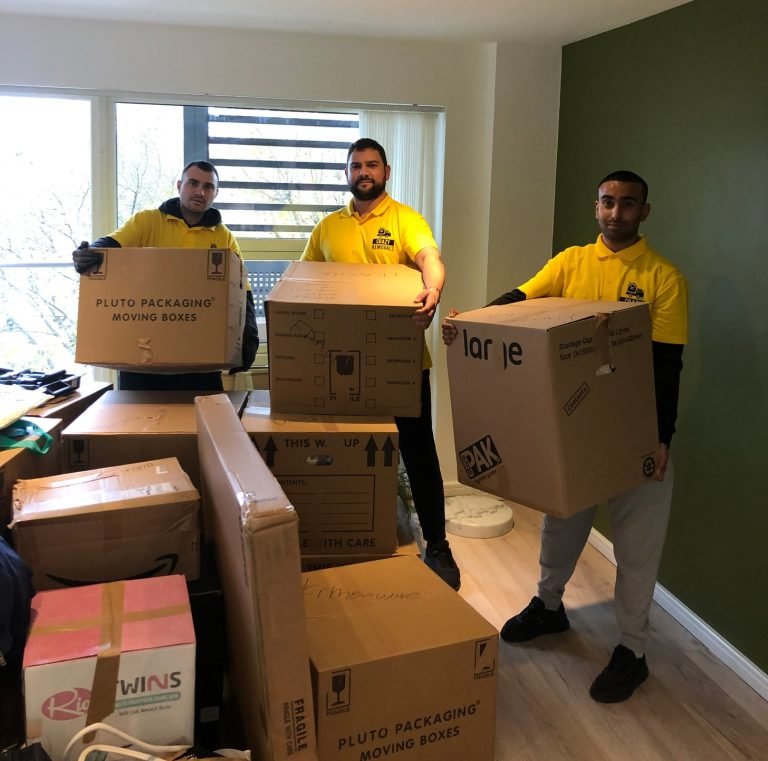 Team of Crazy Removals professionals carrying labeled packing boxes during a home packing service.