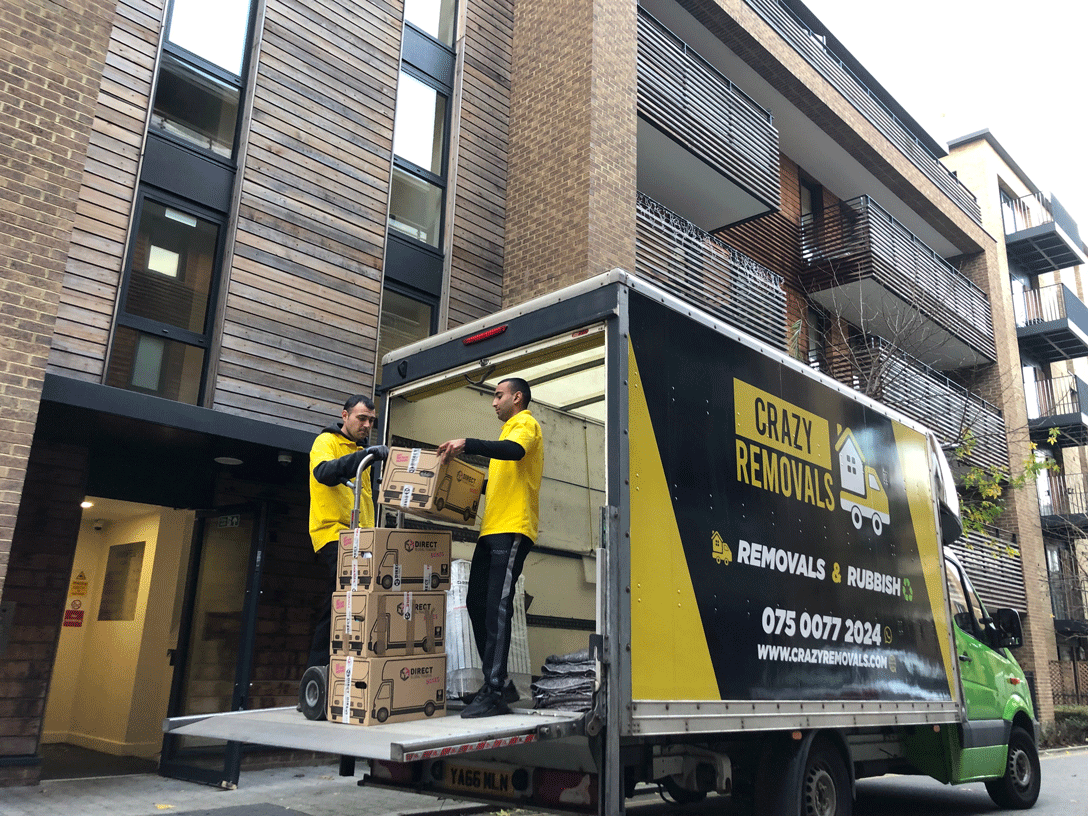 Crazy Removals staff loading boxes into a moving van for an office relocation.